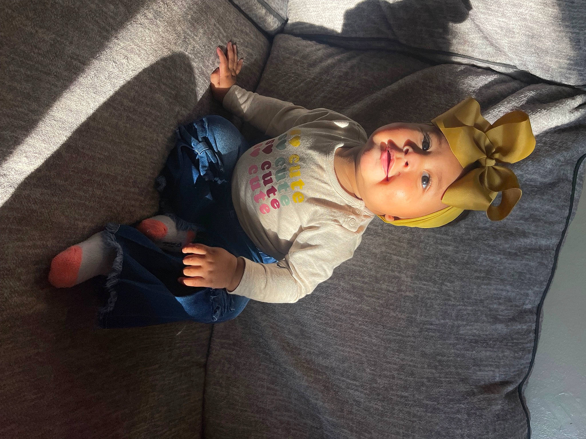 Kailani is registered to the contest to win money with this photo: child, comfort, costume, elbow, eyewear, finger, flooring, foot, fun, hand, headwear, human_leg, joint, knee, leg, mouth, person, personal_protective_equipment, sitting, thigh