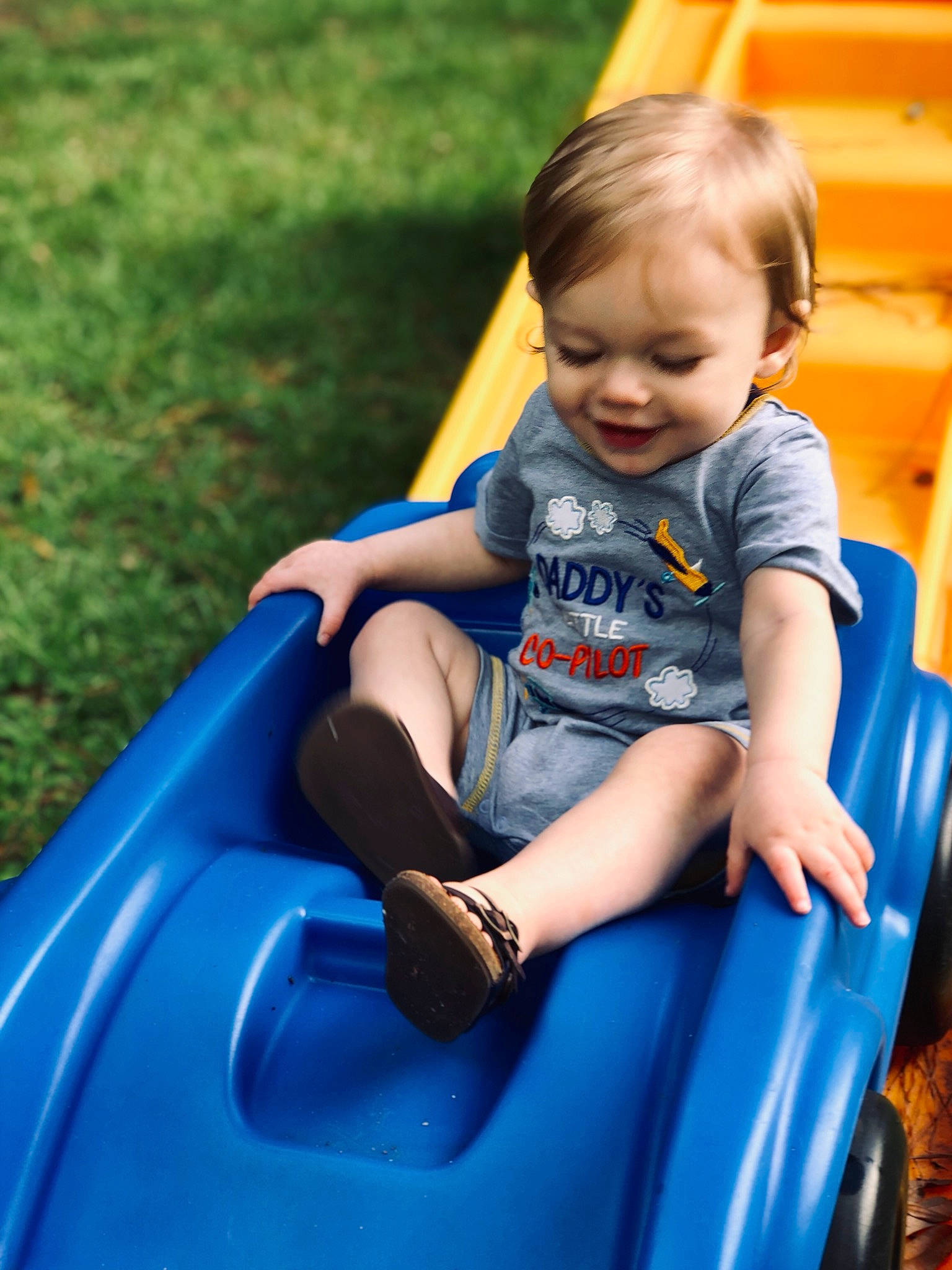 Ransom is registered to the contest to win money with this photo: baby, baby_products, blue, child, fun, grass, human_settlement, joy, leisure, outdoor_play_equipment, person, play, playground, product, public_space, recreation, sitting, skin, smile, summer