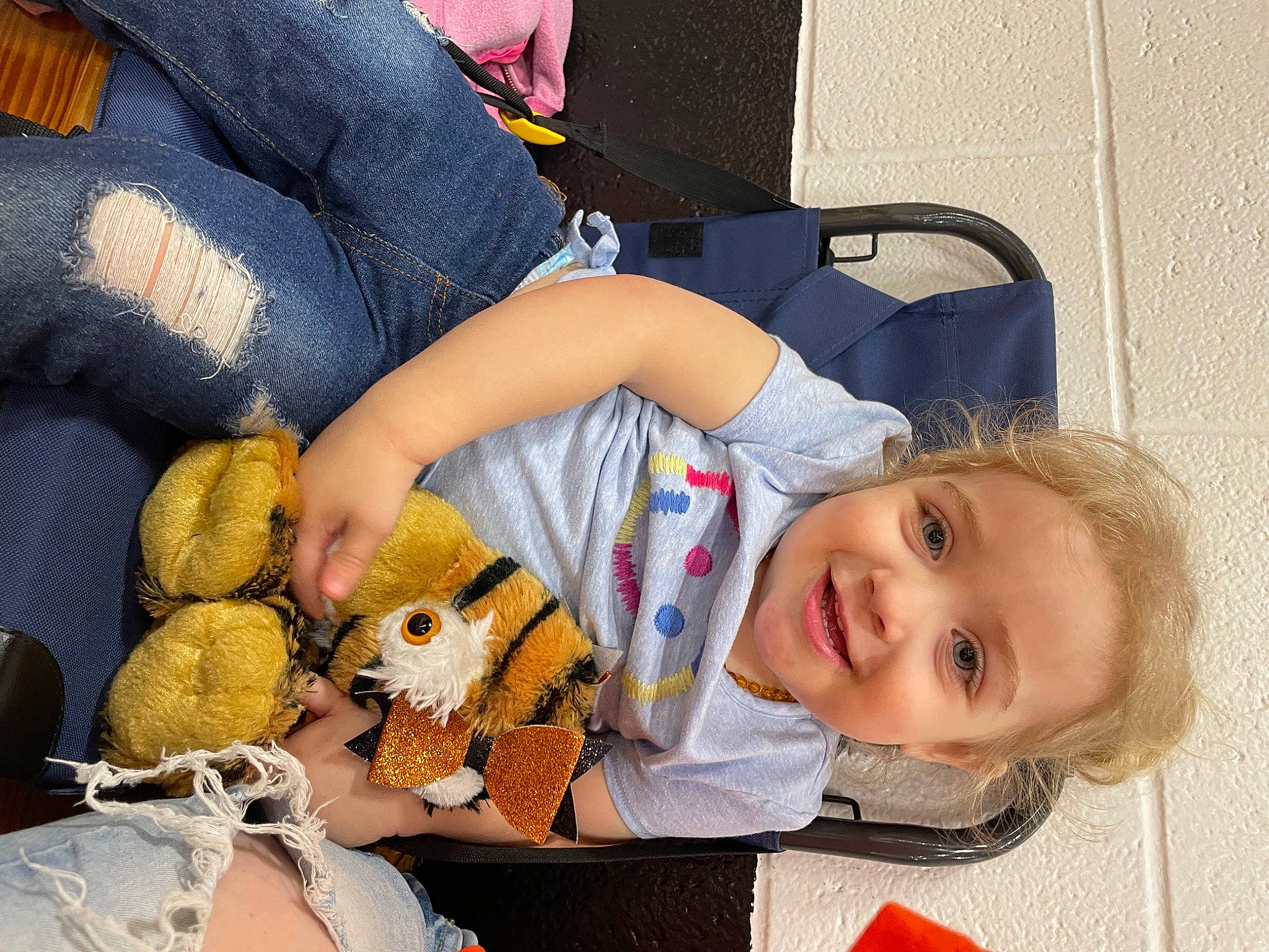 Anakin is registered to the contest to win money with this photo: baby, baby_toddler_clothing, child, comfort, doll, fur, human_leg, joy, mammal, pattern, person, plush, room, sitting, smile, stuffed_toy, teddy_bear, toddler, toy, tree