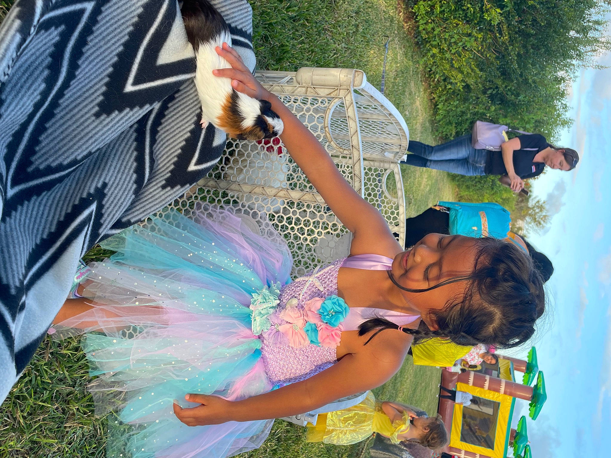 Eva is registered to the contest to win money with this photo: event, fashion_accessory, feather, festival, fun, grass, green, happy, leisure, party, person, photograph, plant, public_event, recreation, snapshot, summer, t_shirt, umbrella, vacation