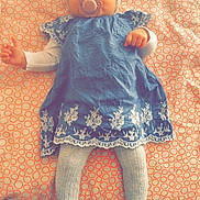 Celya participe au concours pour gagner de l'argent avec cette photo : baby, infant, pacifier, headband, blue_dress, white_tights, lying_down, patterned_blanket, indoors, cute, child, small_hands, sleepy, soft_lighting, portrait, adorable, baby_fashion, resting, calm, cozy