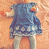 baby, infant, pacifier, headband, blue_dress, white_tights, lying_down, patterned_blanket, indoors, cute, child, small_hands, sleepy, soft_lighting, portrait, adorable, baby_fashion, resting, calm, cozy