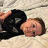 Zehian joined the competition — help win amazing prizes! toddler, child, bed, blanket, quilt, black_shirt, blue_eyes, hair, laying_down, indoor, cute, portrait, face, relaxed, sleepwear, young_child, person, cozy, casual, soft_lighting