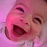Zehian is registered to the contest to win money with this photo: baby, smiling, laughing, white_clothing, closeup, face, child, infant, joy, happy, pink_light, skin, portrait, cute, expression, one_person, indoors, head, young, sleepwear