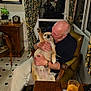 Ash joined the competition — help win amazing prizes! man, dog, indoor, chair, curtains, table, glass, glasses, portrait, plant, clock, floor, vintage, warm_lighting, hand, sitting, pet, affection, home, furniture