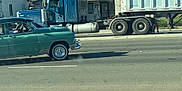 Zeus is registered to the contest to win money with this photo: car, daytime, door, driver, grass, house, metal, residential, road, sidewalk, sky, street, tiled_roof, transportation, truck, urban, vehicle, vintage_car, wheel, window