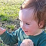 Landon is registered to the contest to win money with this photo: child, cute, daylight, expression, face, fence, grass, green_shirt, hair, happy, nature, outdoor, person, playing, plush_toy, smiling, sunlight, toddler, waving_hand, young_child