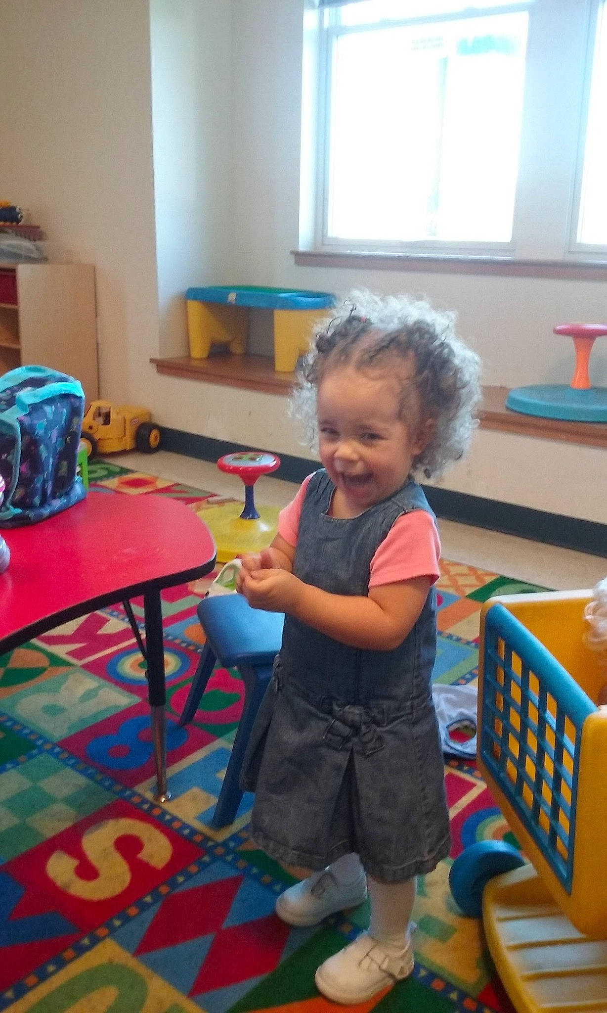 Angelique is registered to the contest to win money with this photo: child, classroom, desk, furniture, kindergarten, person, play, room, school, standing, table, toddler