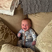 Renesmee is registered to the contest to win money with this photo: baby, smiling, infant, cushion, blanket, cozy, indoors, happy, cute, person, child, seated, textile, plush, fabric, homedecor, relaxed, comfort, portrait, wearing
