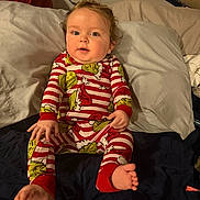 Jettson joined the competition — help win amazing prizes! baby, child, pajamas, bed, pillow, foot, hand, face, blue_eyes, red, white, green, striped_clothing, indoors, curly_hair, person, sleepwear, sitting, cute, infant