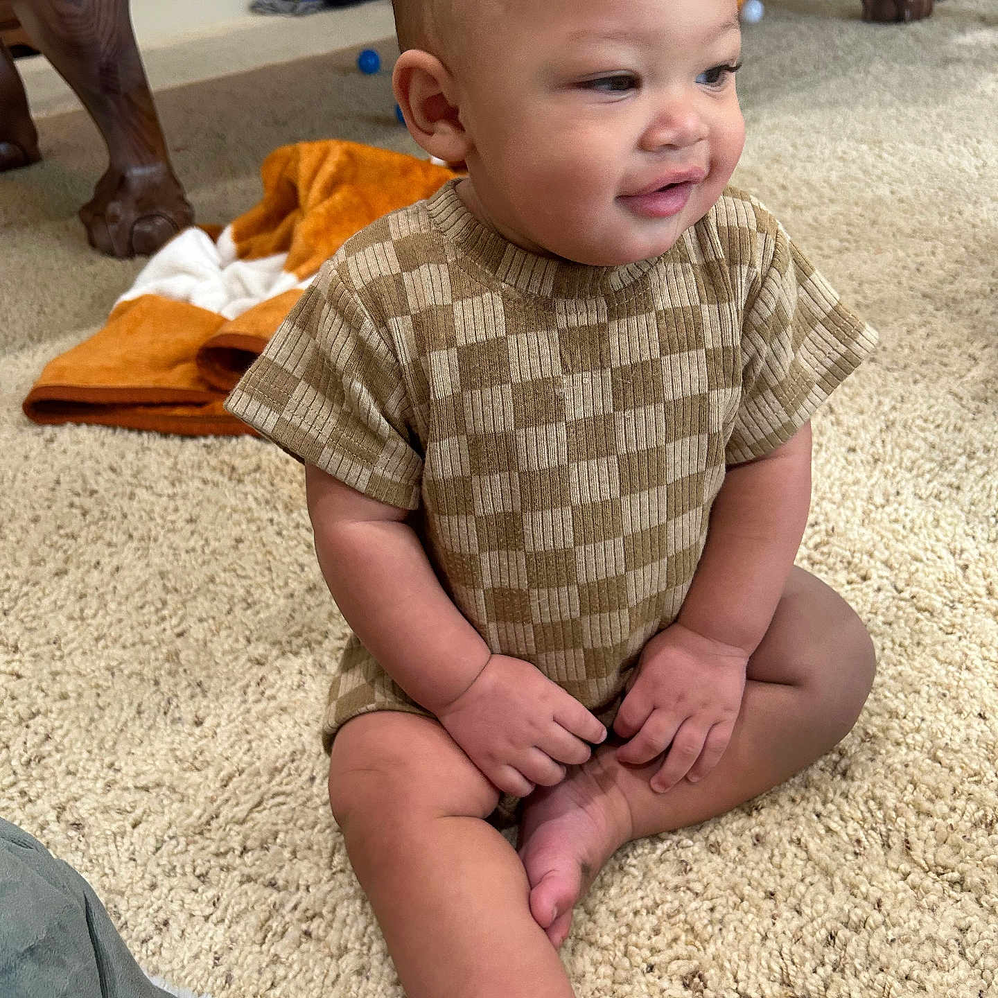 Henry is registered to the contest to win money with this photo: baby, ball, basketball, basketballball, bodypart, clothing, couch, face, finger, furniture, hand, head, homedecor, person, photography, portrait, shorts, sitting, sport, t_shirt