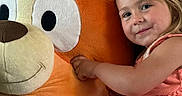 Anastasia is registered to the contest to win money with this photo: child, girl, plush_toy, stuffed_animal, orange, smile, cute, indoor, dress, toy, happy, face, cuddly, childhood, soft, playful, person, portrait, light, cozy
