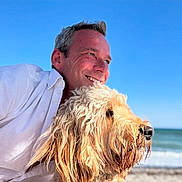 Hoax joined the competition — help win amazing prizes! beach, blue_sky, closeup, companionship, curly_fur, dog, golden_dog, happy, man, nature, outdoor, pet, portrait, sky, smiling, summer, sunny, water, waves, white_shirt