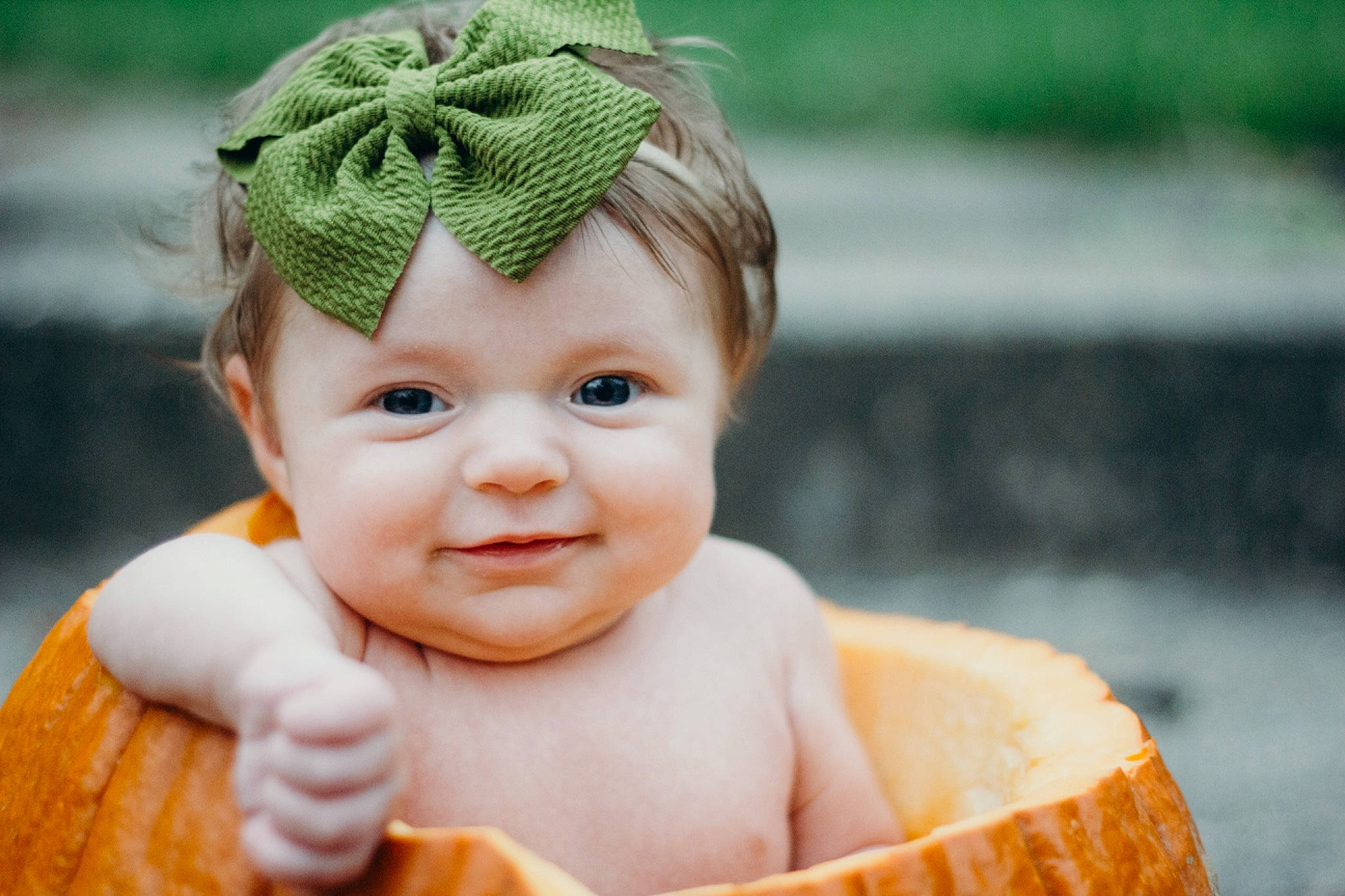 Aniston is registered to the contest to win money with this photo: baby, cap, cheek, chin, dress, eye, face, facial_expression, green, hair, happy, head, human_body, joy, lip, people_in_nature, person, photograph, pink, product