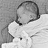 baby, black_and_white, blanket, bunny, child, closeup, cozy, cute, infant, monochrome, newborn, peaceful, person, plush_toy, portrait, resting, sleeping, soft_texture, sweater, young