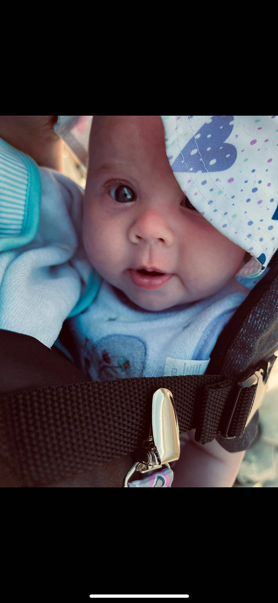 Zoella is registered to the contest to win money with this photo: baby, baby_carriage, baby_products, baby_toddler_clothing, cheek, child, comfort, cool, facial_expression, fashion_accessory, happy, headwear, iris, lip, mouth, nose, outerwear, person, sitting, skin