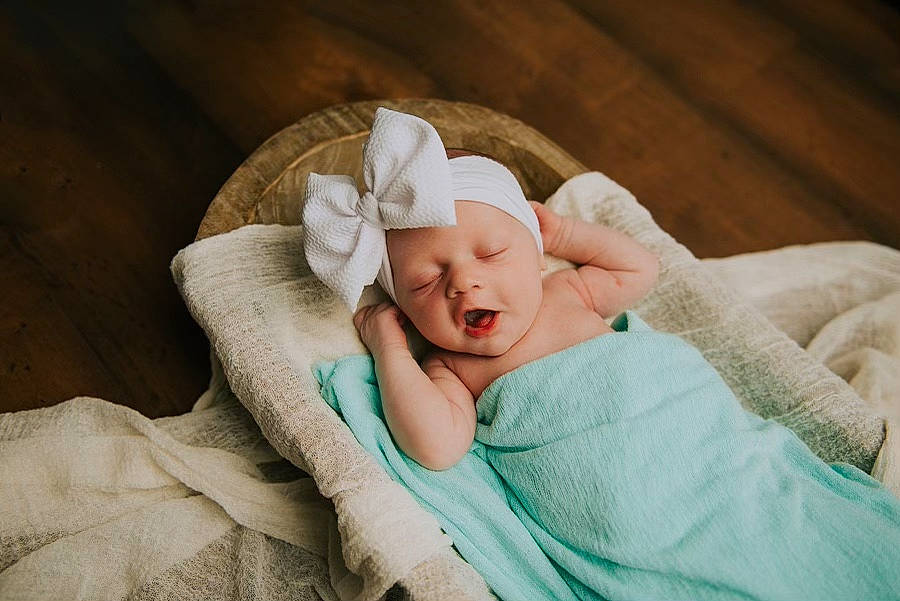 Mckinley is registered to the contest to win money with this photo: baby, baby_sleeping, baby_toddler_clothing, bedding, bedtime, blanket, bonnet, comfort, headwear, linens, nap, person