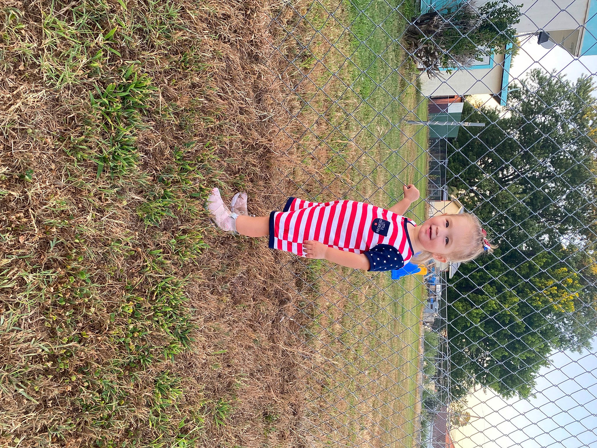 Mason joined the competition — help win amazing prizes! child, electric_blue, fence, fun, grass, happy, joy, landscape, leaf, leisure, mesh, people_in_nature, person, plant, shadow, shrub, smile, soil, spring, toddler