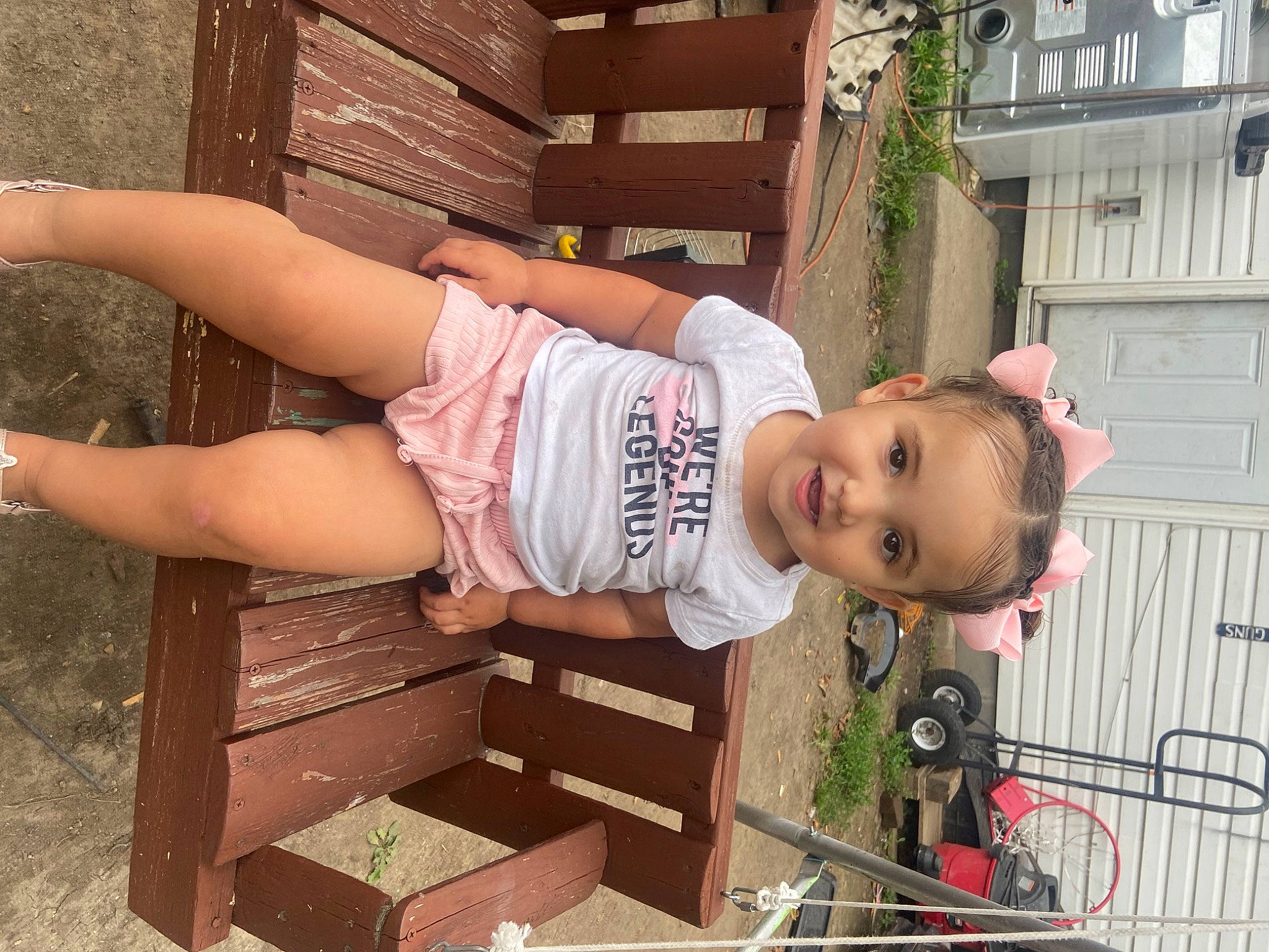 Emberlyn is registered to the contest to win money with this photo: baby, baby_toddler_clothing, child, fun, grass, happy, hat, human_leg, joy, leisure, person, pink, plant, sitting, skin, smile, thigh, tire, toddler, tree