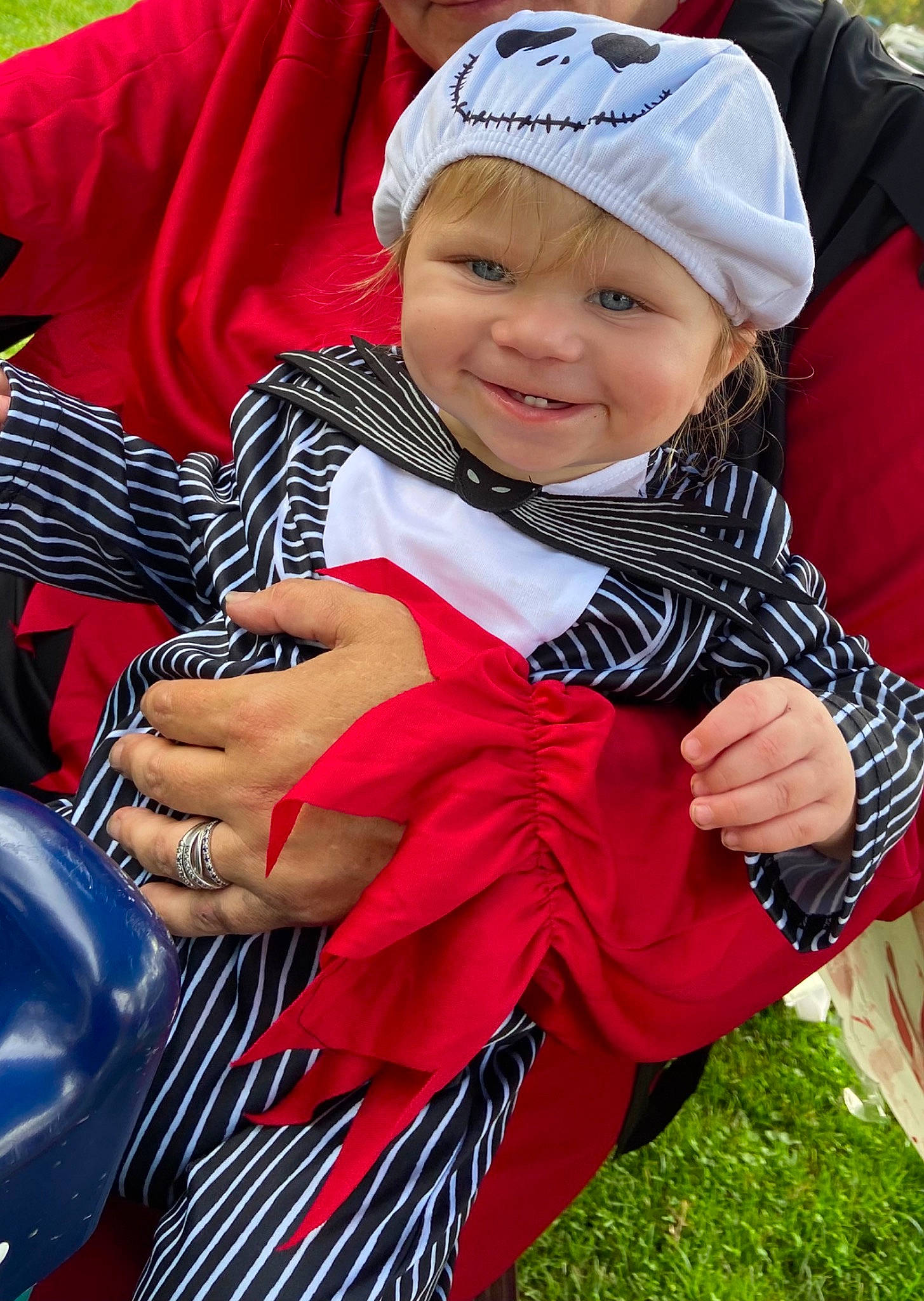 Goku is registered to the contest to win money with this photo: baby, baby_toddler_clothing, cap, event, finger, fun, grass, happy, headgear, headwear, joy, leisure, magenta, people_in_nature, person, pink, plant, recreation, red, sitting