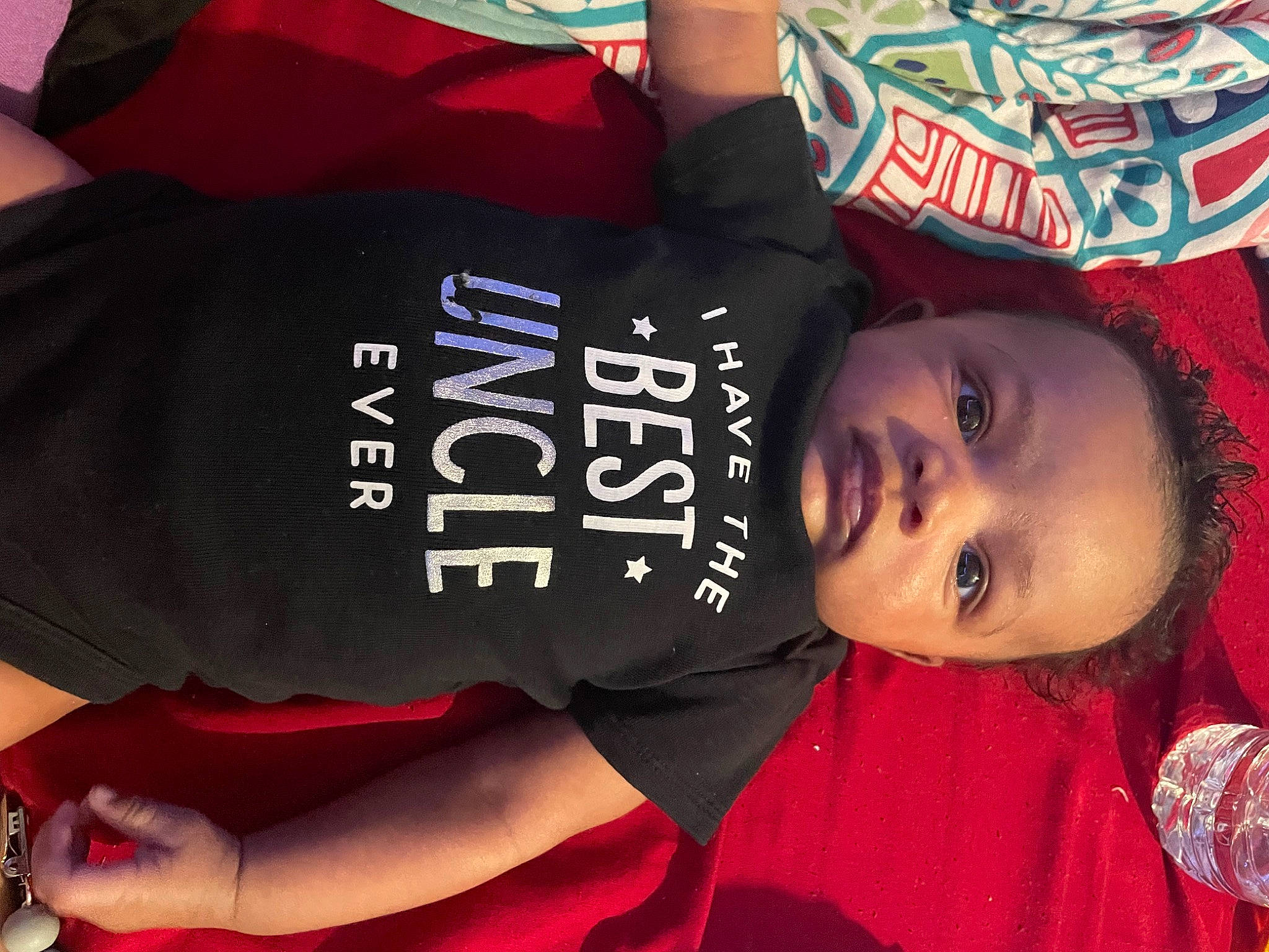 Jordon is registered to the contest to win money with this photo: black_hair, child, cool, elbow, fun, hairstyle, happy, hat, pattern, person, plant, red, sleeve, smile, t_shirt, toddler