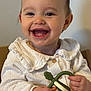 baby, child, smile, teether, toy, white_clothing, happy, face, hands, indoor, portrait, cute, infant, sitting, young_child, closeup, skin, person, mouth_open, eyes
