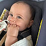 baby, infant, pacifier, hand, blanket, car_seat, child, face, eyes, cute, chewing, clothing, indoors, sitting, soft_texture, warning_label, closeup, skin, head, person