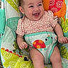 Leilani is registered to the contest to win money with this photo: baby, smiling, infant, baby_seat, colorful, animal_print, happy, child, cute, clothing, indoors, comfort, joy, playful, face, legs, sitting, young_child, pattern, fabric