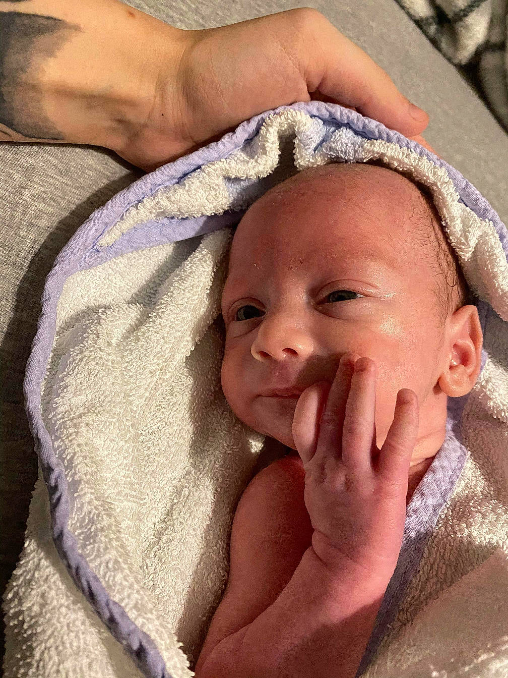 Kevin is registered to the contest to win money with this photo: baby, baby_toddler_clothing, child, costume_accessory, eyebrow, hair_accessory, person, photography, skin, towel