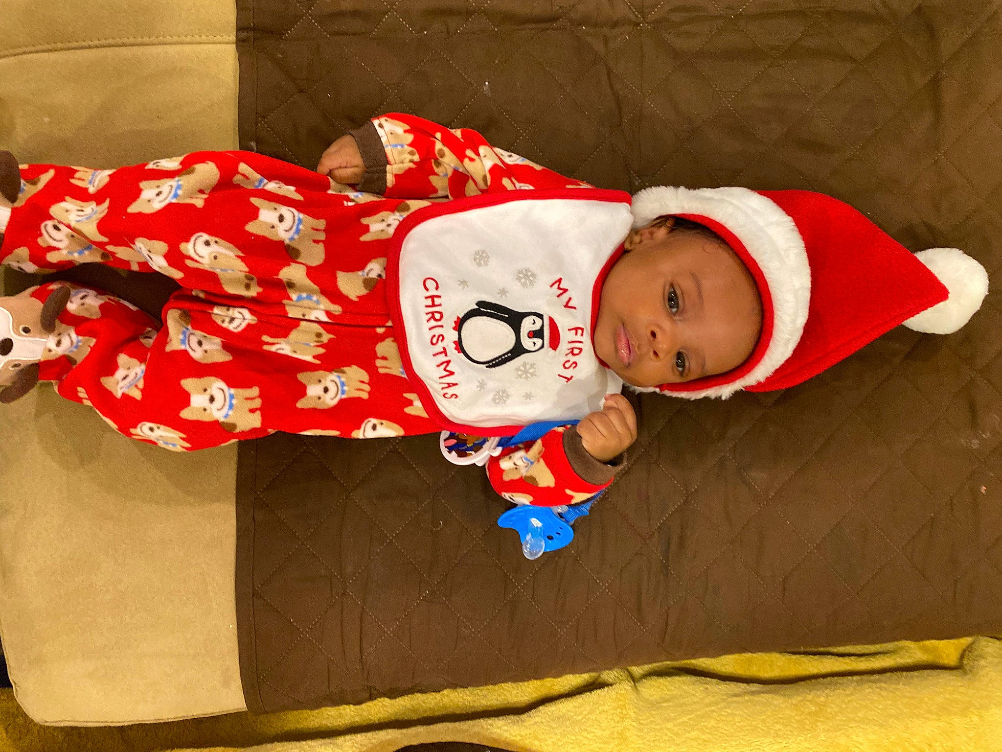 Cassius is registered to the contest to win money with this photo: baby, baby_sleeping, baby_toddler_clothing, carmine, child, christmas, christmas_eve, comfort, costume_hat, fictional_character, happy, hat, holiday, human_body, lap, person, room, sitting, sleeve, sock