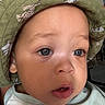 animal_print, baby, blue_eyes, bucket_hat, casual, child, close_up, clothing, curious, cute, expression, face, hat, headwear, indoor, person, portrait, skin, toddler, young_child