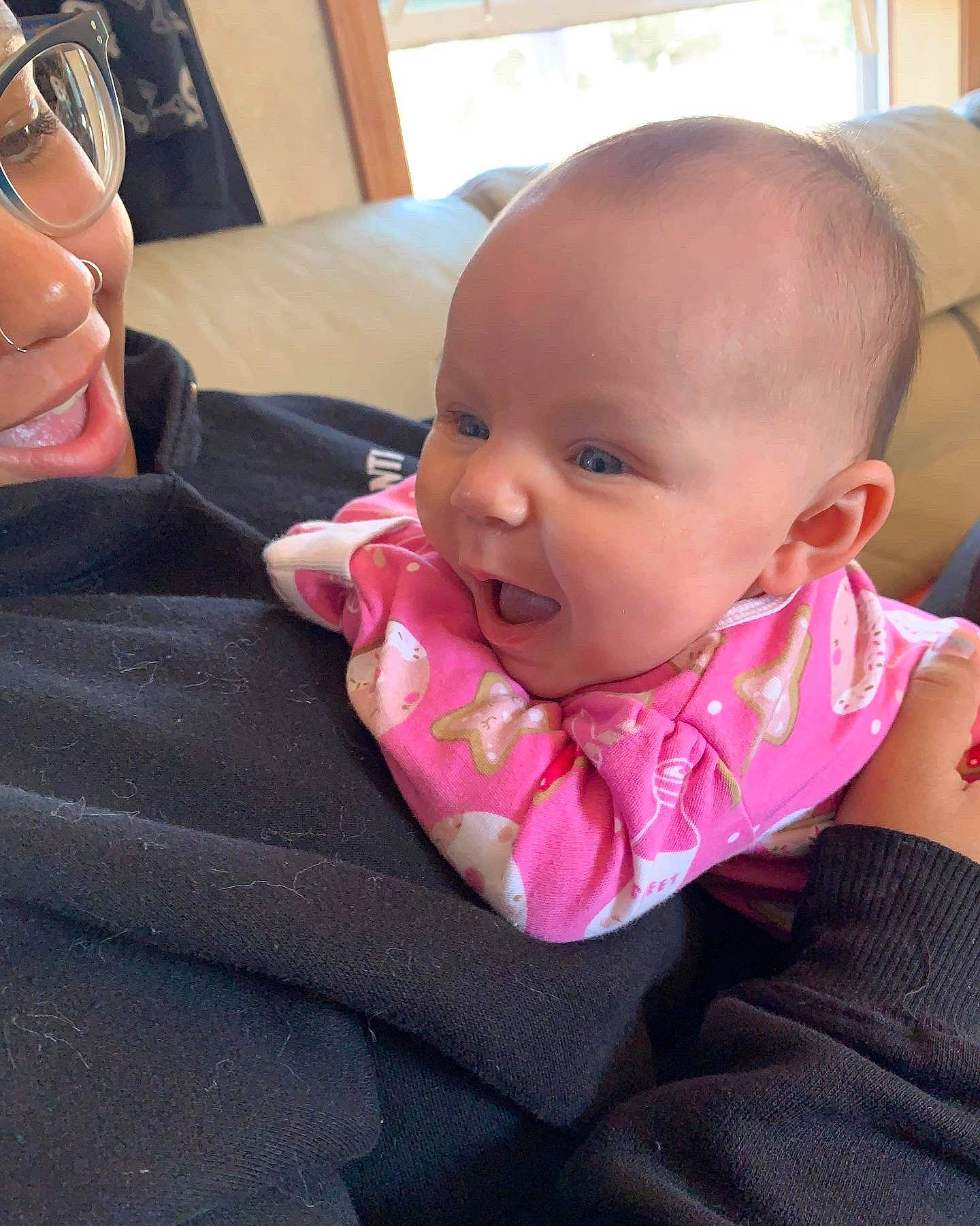 April is registered to the contest to win money with this photo: baby, baby_products, baby_toddler_clothing, cheek, child, comfort, ear, electronic_device, eyelash, eyewear, finger, fun, happy, lip, mouth, nose, person, sitting, skin, smile