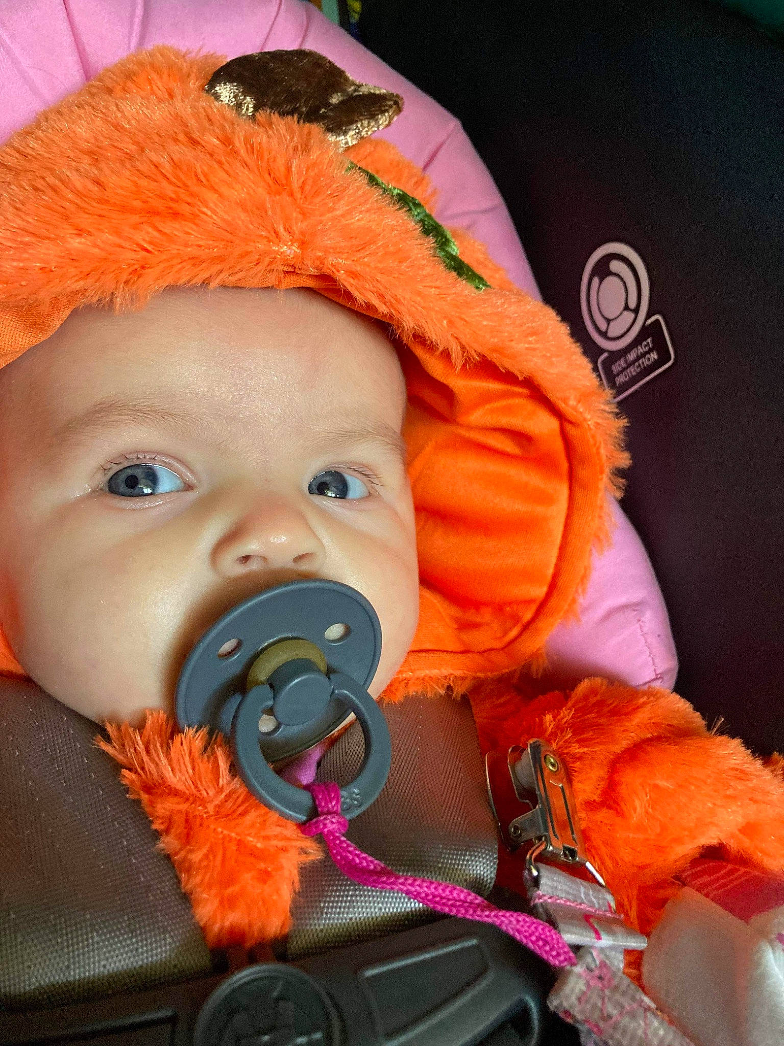 April is registered to the contest to win money with this photo: baby, baby_carriage, baby_products, baby_safety, baby_toddler_clothing, beanie, cheek, child, comfort, costume, eye, fun, happy, head, headwear, iris, nose, orange, person, personal_protective_equipment