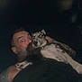 Chaos is registered to the contest to win money with this photo: animal, beard, closeup, collar, companionship, dark, dog, expression, face, holding, indoor, man, night, person, pet, portrait, spotted_dog, surprised, tattoo, wide_eyes