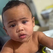 Caleb is registered to the contest to win money with this photo: baby, child, face, eyes, skin, expression, indoor, curious, infant, portrait, human, young, cute, closeup, person, small, hand, soft, exploring, background_blur