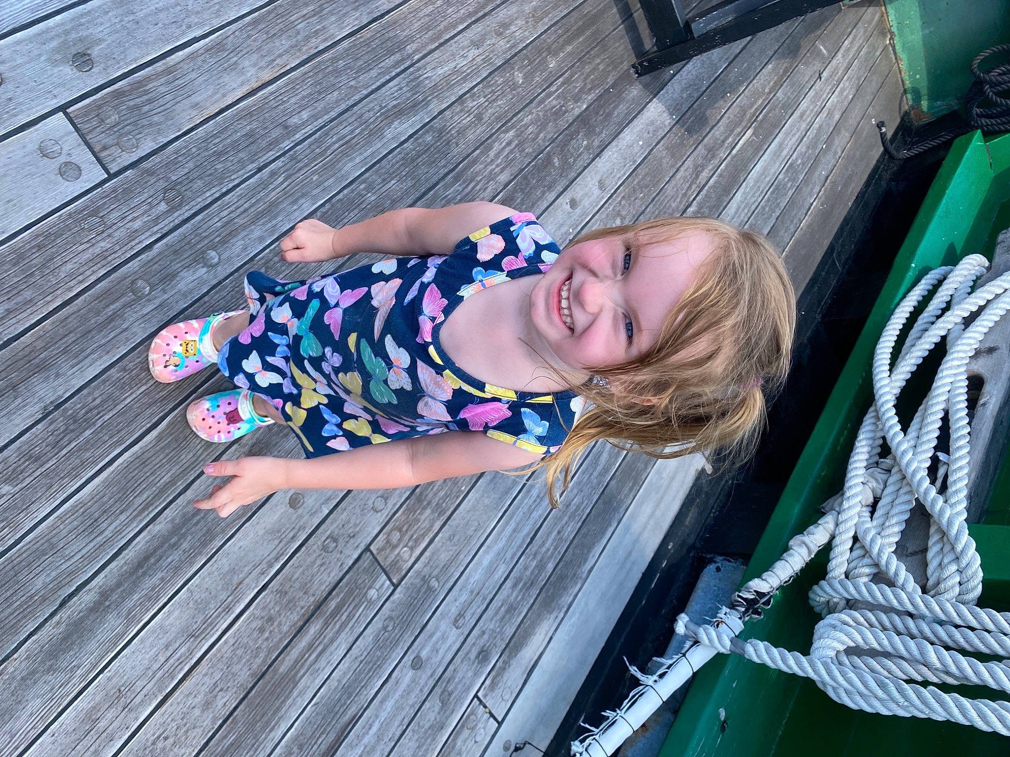 Scarlette is registered to the contest to win money with this photo: baby, baby_toddler_clothing, blue, child, electric_blue, flooring, fun, grass, green, happy, hardwood, joy, leisure, magenta, pattern, person, purple, sitting, smile, toddler