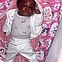baby, infant, child, blanket, pink, white_clothing, onesie, pants, lying_down, face, curly_hair, baby_accessories, pacifier, soft_toys, crib, cozy, cute, portrait, indoors, sleepwear