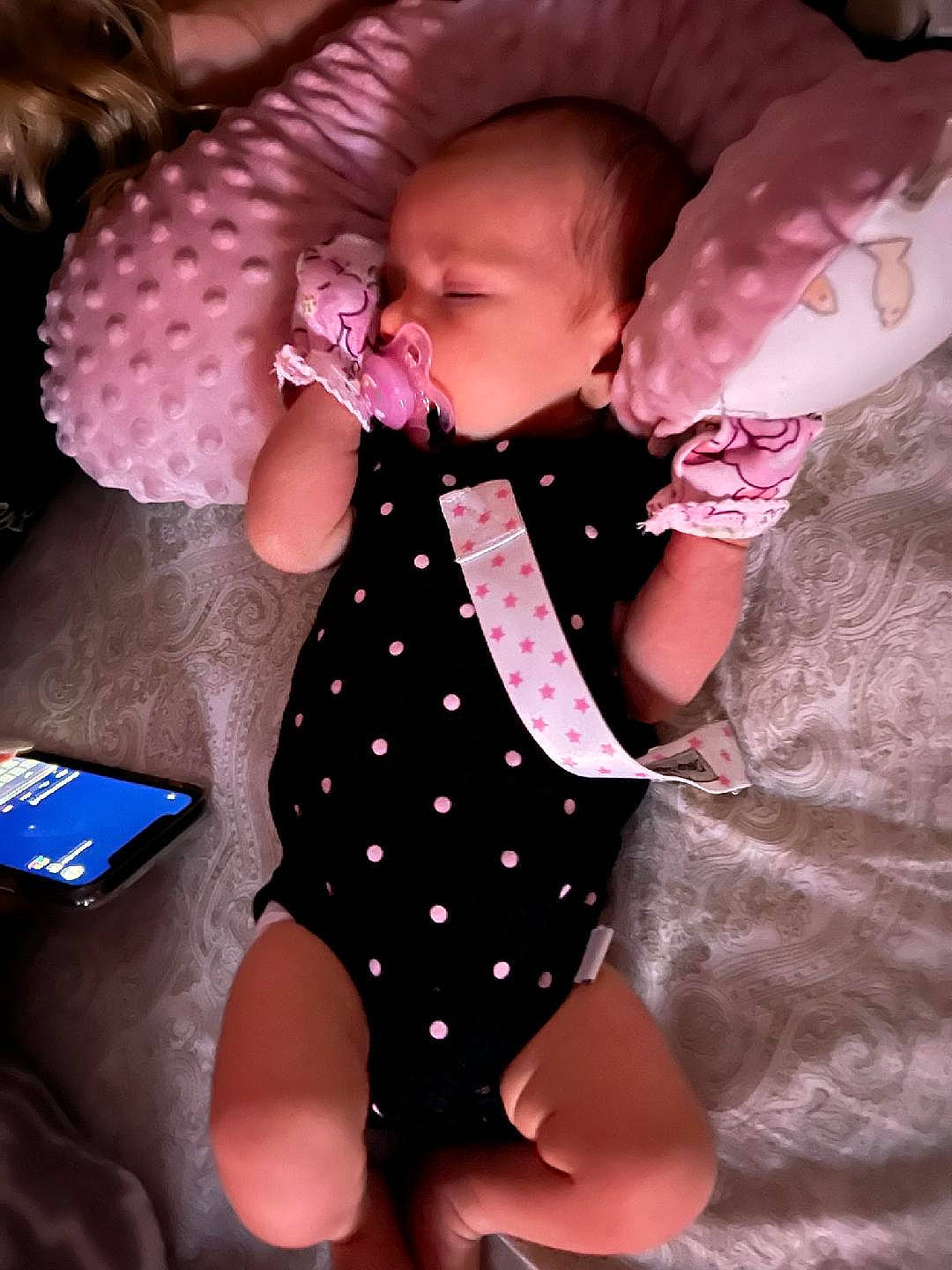 Kinsleigh is registered to the contest to win money with this photo: arm, baby, baby_toddler_clothing, child, comfort, communication_device, dress, finger, gesture, happy, magenta, mobile_phone, pattern, pink, skin, sleeve, tablet_computer, textile, thigh, toddler