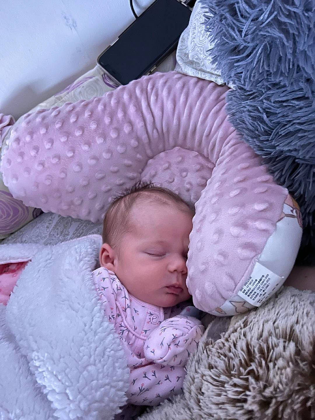 Kinsleigh is registered to the contest to win money with this photo: baby, baby_products, baby_sleeping, baby_toddler_clothing, bedding, bedtime, cheek, child, comfort, face, headgear, infant_bed, linens, pattern, person, pink, purple, skin, textile, toddler