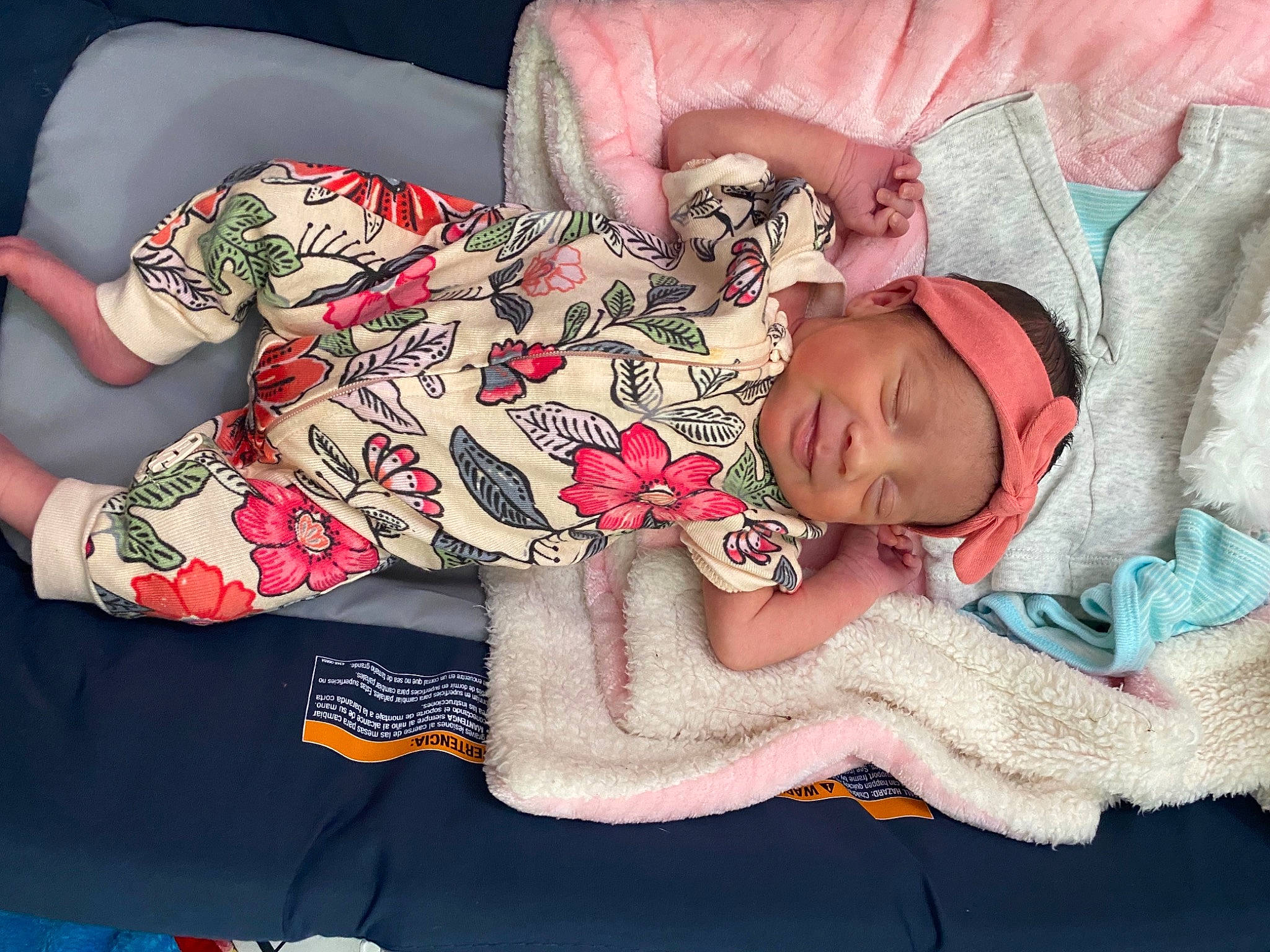 Brynlie is registered to the contest to win money with this photo: arm, baby, baby_sleeping, baby_toddler_clothing, comfort, cool, finger, hand, headgear, headwear, human_body, mouth, nail, neck, organ, person, pink, product, skin, sleeve