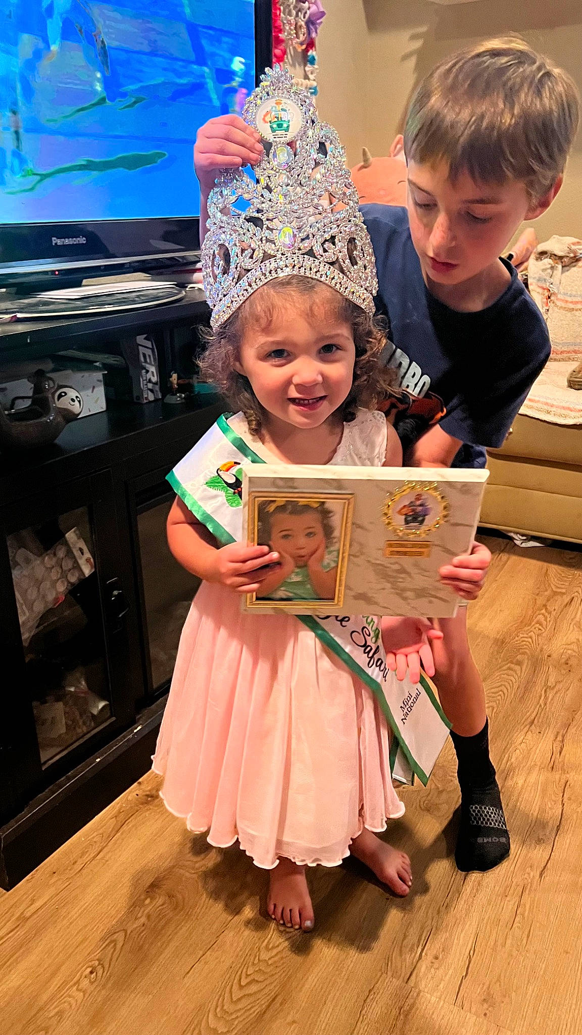 Brynlie Rayne joined the competition — help win amazing prizes! child, costume, costume_hat, event, flooring, fun, happy, hardwood, headwear, holiday, joy, party, party_supply, people, person, pink, room, sandal, smile, television
