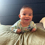 Harper joined the competition — help win amazing prizes! baby, smiling, infant, bed, pillow, onesie, clothing, happy, face, child, headboard, indoor, cute, lying_down, young_child, propped_up, skin, person, toddler, light