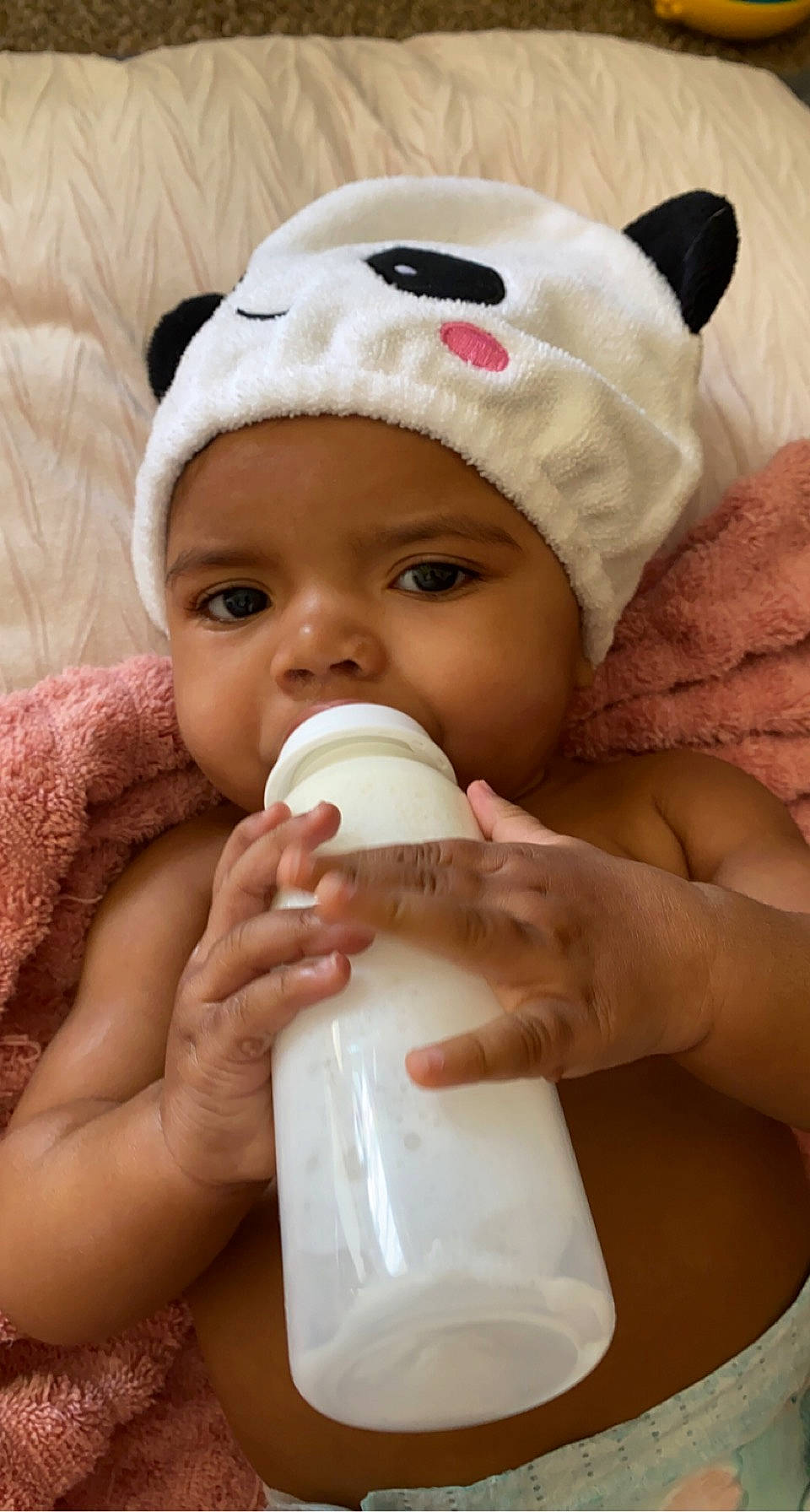 Maliah joined the competition — help win amazing prizes! baby, baby_bottle, bottle, cap, cheek, drinking, drinkware, eyelash, face, facial_expression, finger, gesture, hand, headwear, lip, milk, nose, person, plastic_bottle, skin