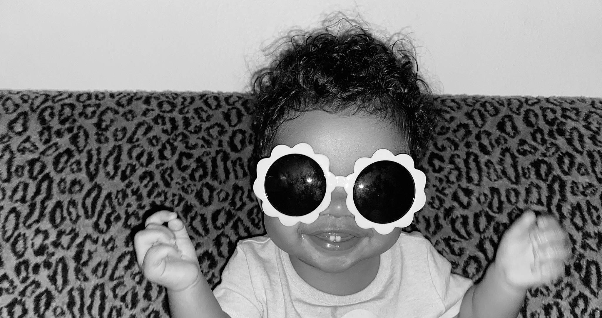 Maliah joined the competition — help win amazing prizes! black, black_and_white, chin, clothing, eyewear, face, flash_photography, gesture, goggles, hairstyle, hand, happy, human, mouth, nose, person, sleeve, smile, sunglasses, vision_care