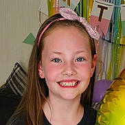 Isabelle joined the competition — help win amazing prizes! child, girl, smile, birthday_party, balloon, headband, pink_bow, long_hair, happy, face, celebration, indoor, colorful, decorations, couch, pillow, portrait, person, young, festive