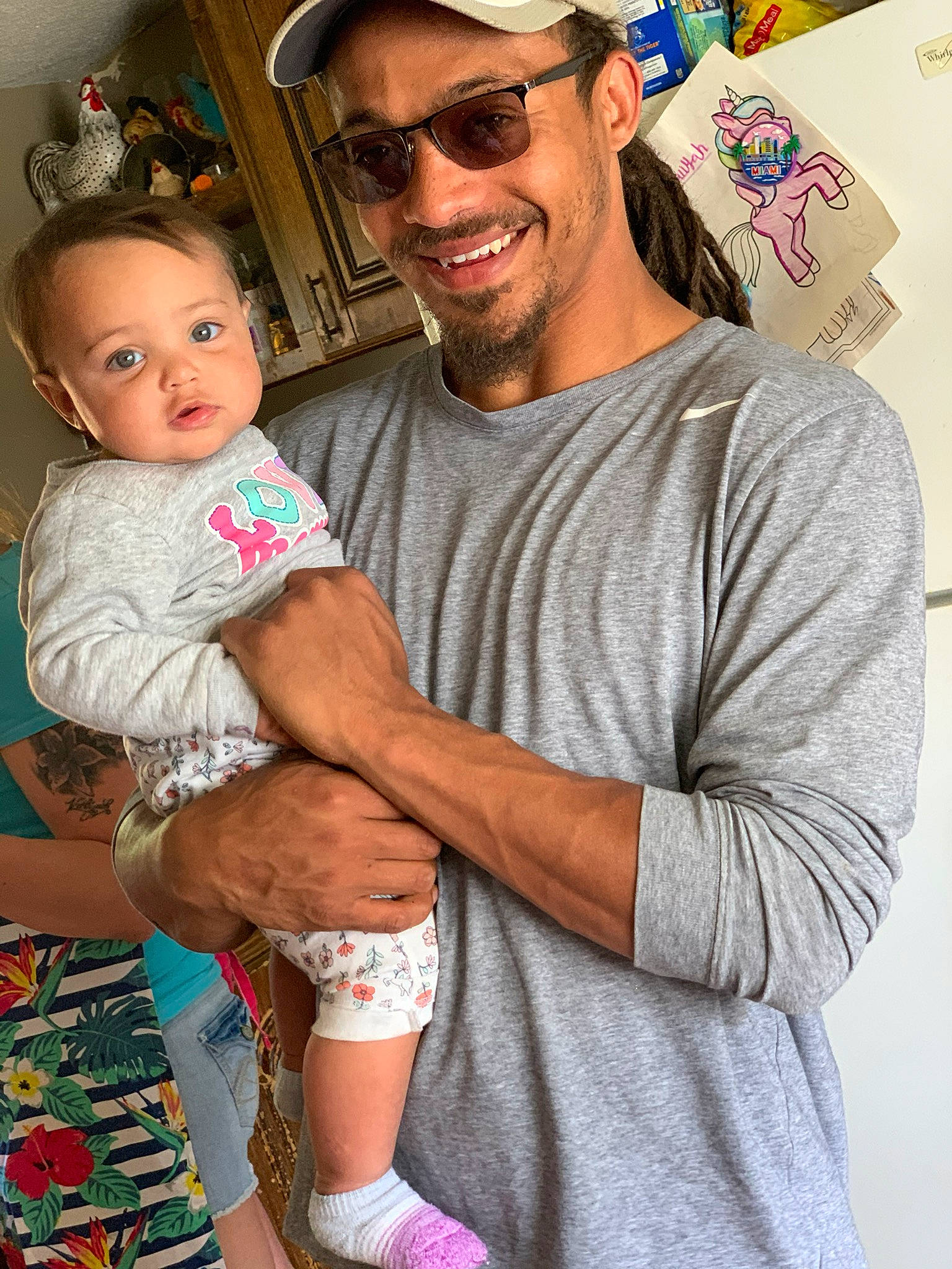 Emmarie is registered to the contest to win money with this photo: arm, baby, child, eyewear, family, glasses, happy, headwear, joy, people, person, sleeve, smile, t_shirt, toddler, vacation