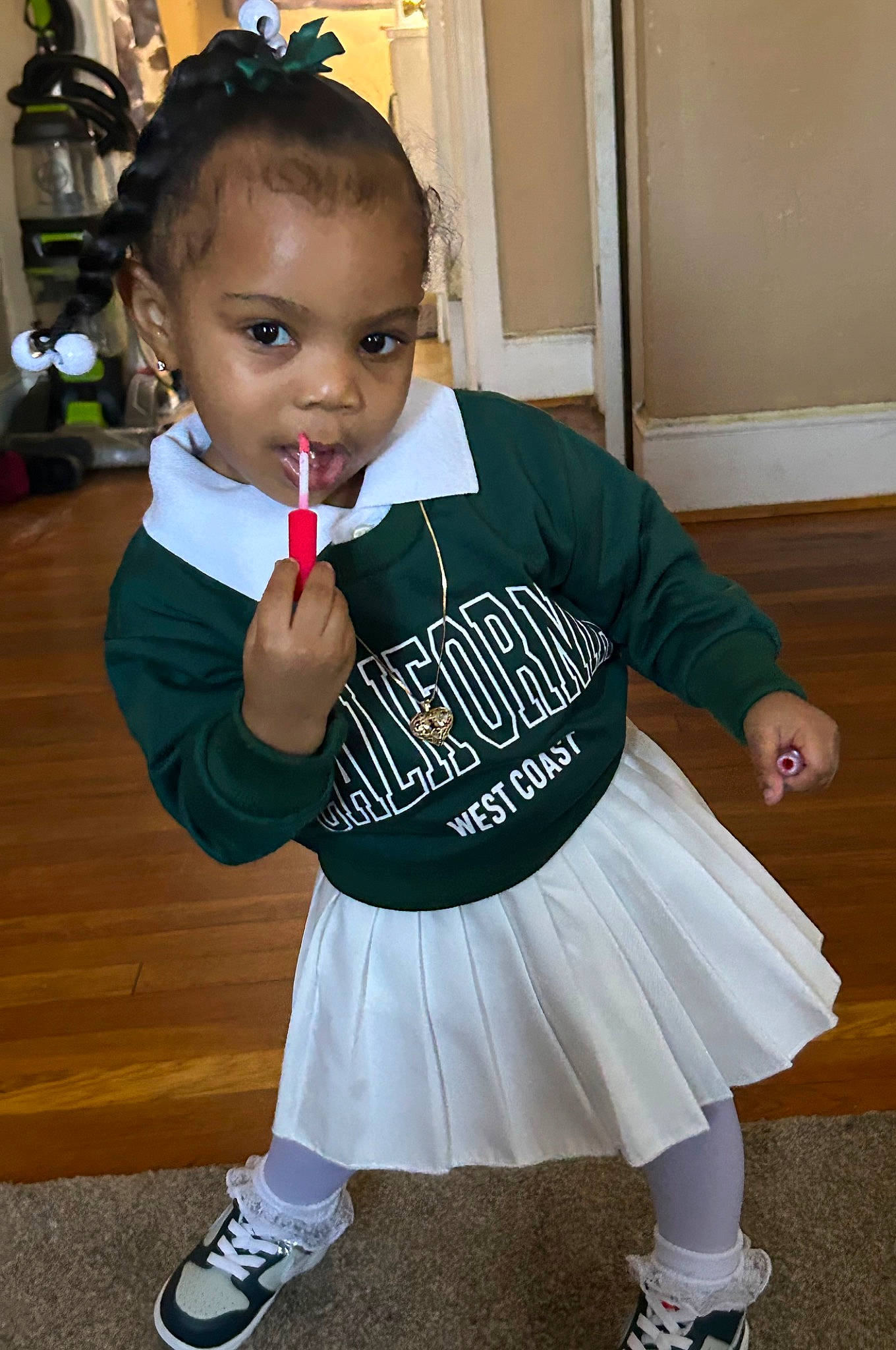 Kelsey is registered to the contest to win money with this photo: baby_toddler_clothing, child, costume, face, fashion_accessory, happy, head, human_leg, knee, person, pigtail, room, school_uniform, sleeve, sock, sportswear, t_shirt, toddler, uniform, white