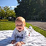 baby, child, blanket, grass, outdoor, sunlight, smiling, happy, nature, sky, trees, park, crawling, clothing, infant, daytime, person, play, greenery, cute