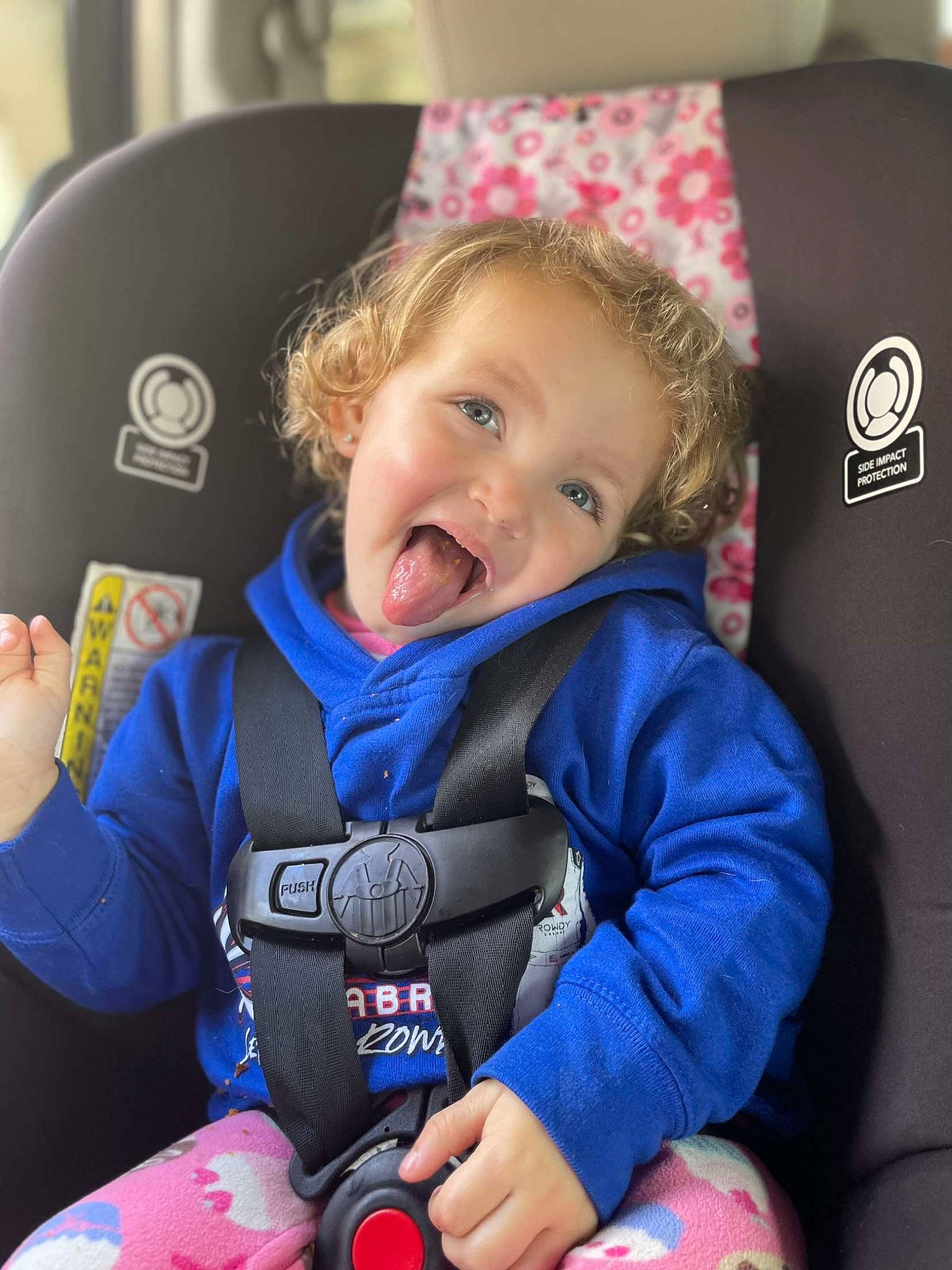Delaney is registered to the contest to win money with this photo: auto_part, baby, baby_carriage, baby_in_car_seat, baby_products, baby_toddler_clothing, car_seat, car_seat_cover, child, comfort, electric_blue, fun, happy, person, personal_protective_equipment, seat_belt, sleeve, smile, steering_wheel, toddler