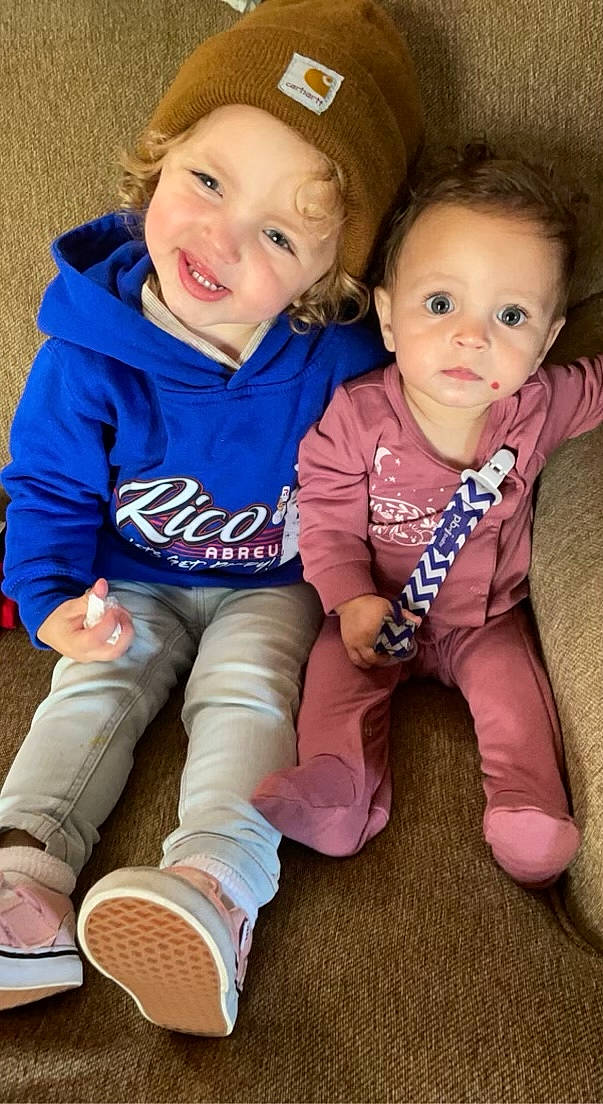 Delaney is registered to the contest to win money with this photo: baby_toddler_clothing, cheek, child, cool, face, facial_expression, finger, fun, happy, headwear, human, iris, joy, leg, mammal, nose, organ, person, pink, skin